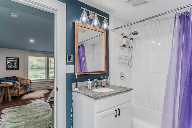 bathroom featuring shower / bath combo, vanity, and wood finished floors