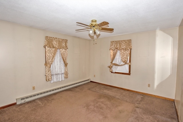 carpeted spare room featuring ceiling fan, baseboard heating, and a textured ceiling