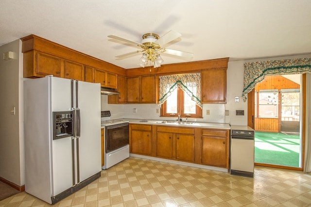 kitchen featuring white appliances, ceiling fan, and sink