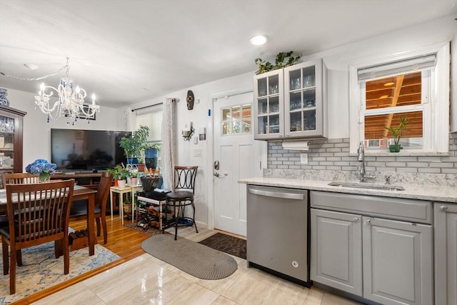 80 Messinger St, Boston, MA 02126 - kitchen featuring stainless steel dishwasher, a sink, gray cabinets, tasteful backsplash, and glass insert cabinets