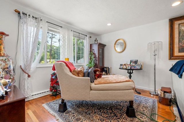 80 Messinger St, Boston, MA 02126 - living area with wood finished floors, recessed lighting, a baseboard heating unit, and baseboards