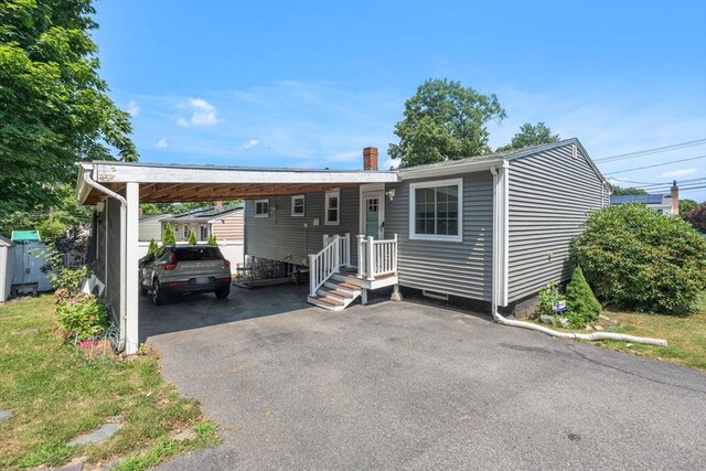80 Messinger St, Boston, MA 02126 - manufactured / mobile home featuring driveway, a carport, and a chimney