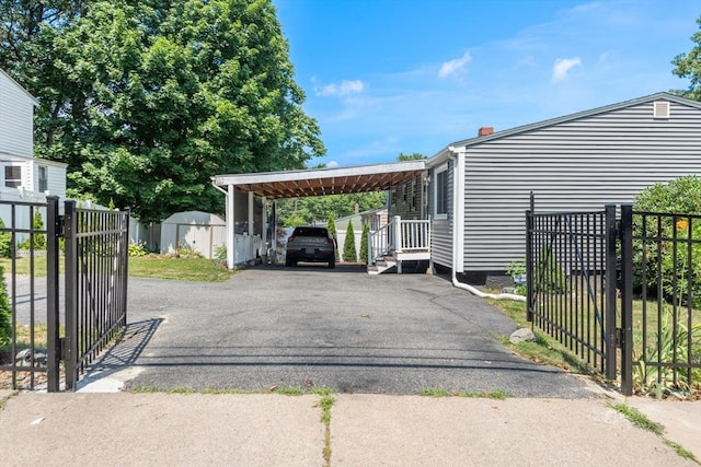 80 Messinger St, Boston, MA 02126 - view of parking / parking lot with a gate, asphalt driveway, and a storage unit