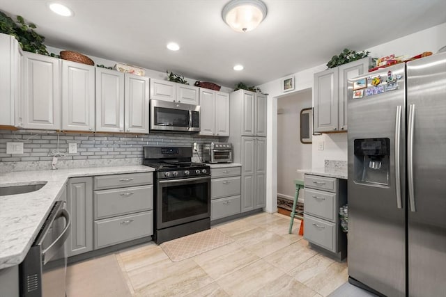 80 Messinger St, Boston, MA 02126 - kitchen featuring stainless steel appliances, backsplash, gray cabinets, light stone countertops, and recessed lighting