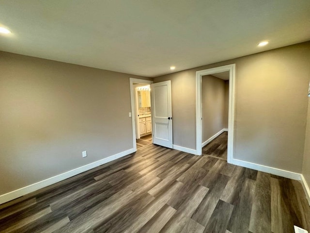 unfurnished bedroom with dark wood-type flooring