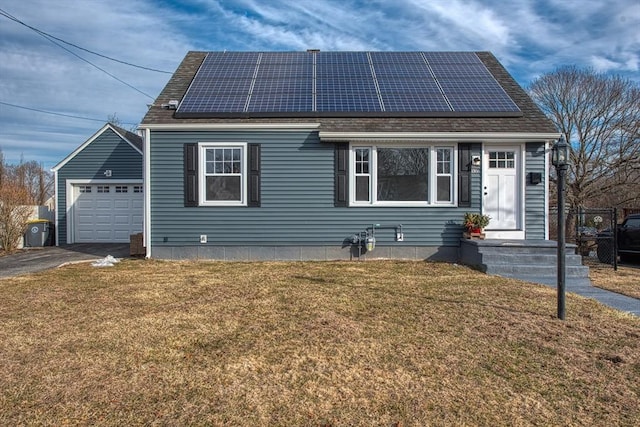 view of front of house with a shingled roof, aphalt driveway, solar panels, and a front yard