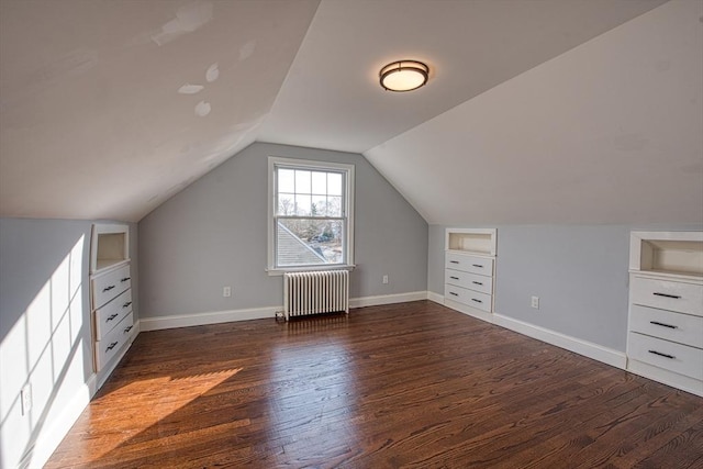 bonus room with lofted ceiling, baseboards, built in features, dark wood-style floors, and radiator heating unit