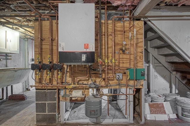 utility room featuring water heater