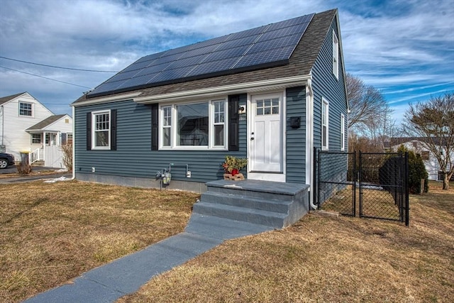 view of front of home with a shingled roof, a gate, fence, roof mounted solar panels, and a front lawn