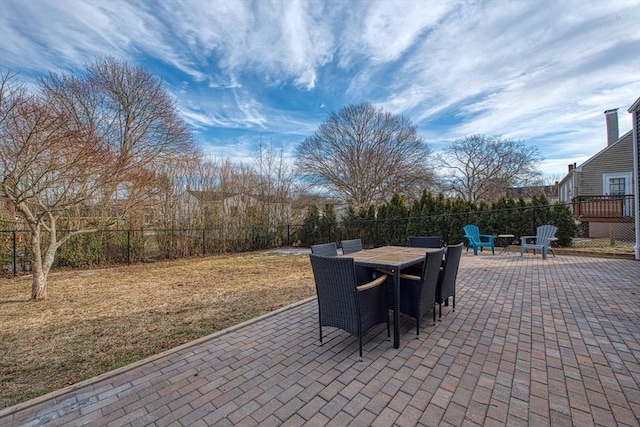 view of patio featuring outdoor dining area and fence