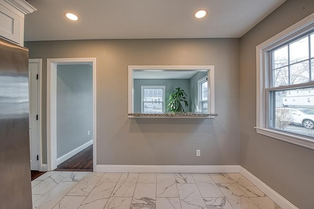 unfurnished room with marble finish floor, baseboards, and recessed lighting