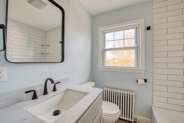 full bath with visible vents, toilet, radiator heating unit, walk in shower, and vanity