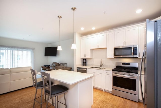 120 University Ave Unit 2202, Westwood, MA 02090 - kitchen with appliances with stainless steel finishes, open floor plan, light wood-type flooring, light countertops, and recessed lighting