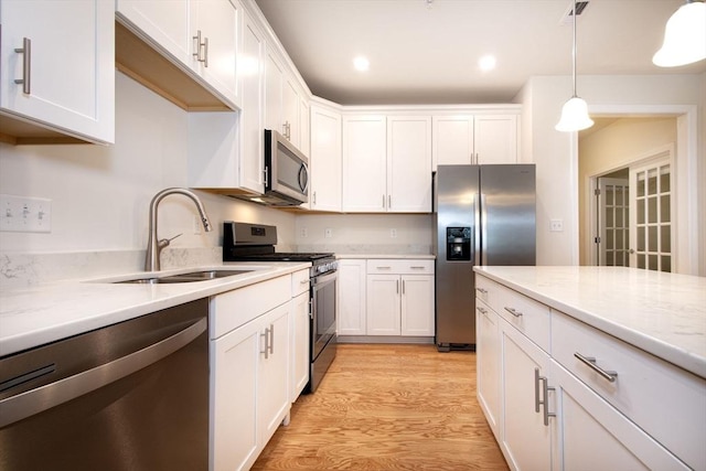 120 University Ave Unit 2202, Westwood, MA 02090 - kitchen featuring stainless steel appliances, white cabinets, light wood-type flooring, decorative light fixtures, and recessed lighting