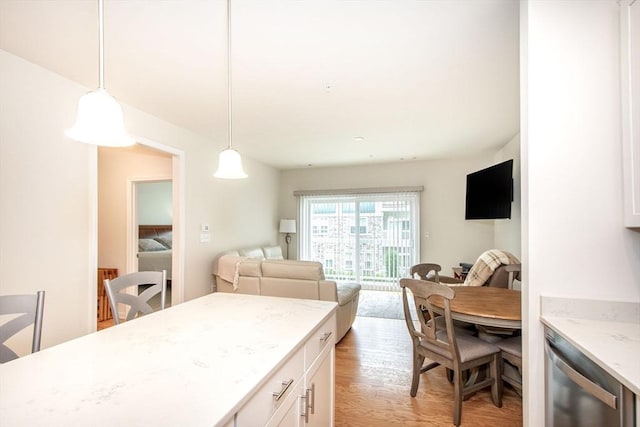 120 University Ave Unit 2202, Westwood, MA 02090 - kitchen with dishwasher, white cabinetry, light wood-style floors, open floor plan, and pendant lighting