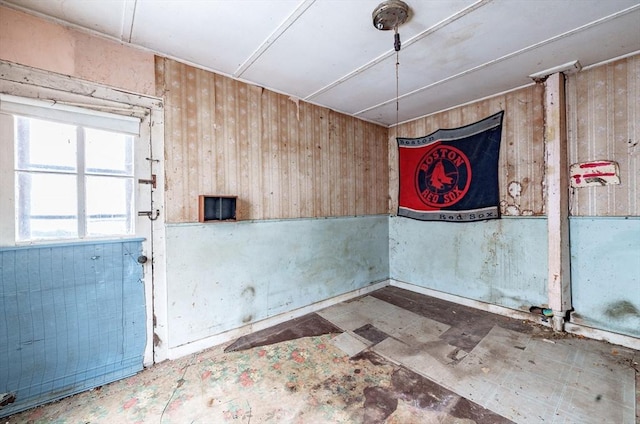 unfurnished room with wooden walls