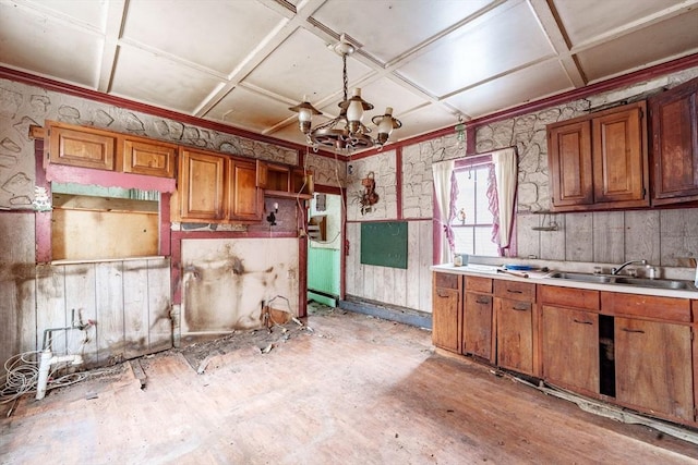 kitchen with sink, an inviting chandelier, and coffered ceiling