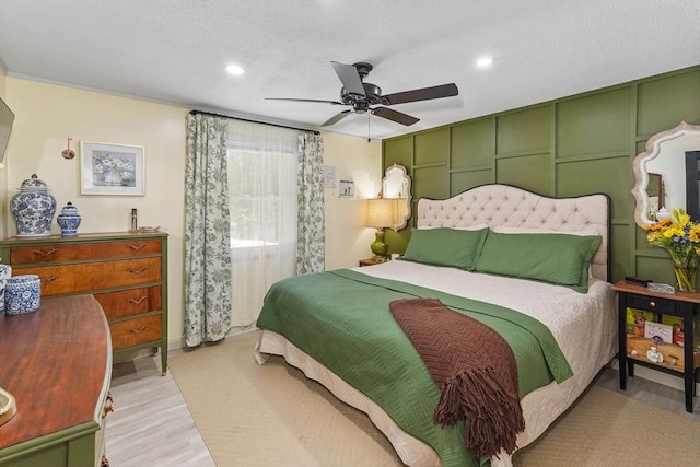 bedroom featuring ceiling fan and light hardwood / wood-style flooring