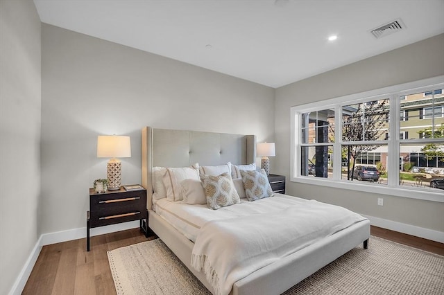 bedroom featuring baseboards, multiple windows, and visible vents