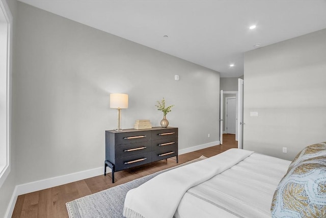 bedroom with baseboards, recessed lighting, and dark wood-style floors