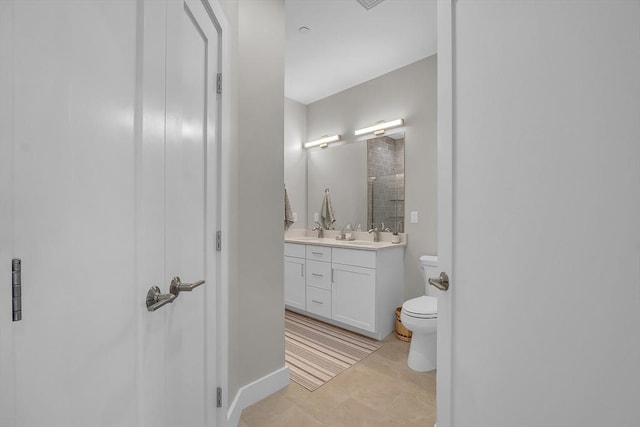 bathroom with toilet, vanity, and a shower