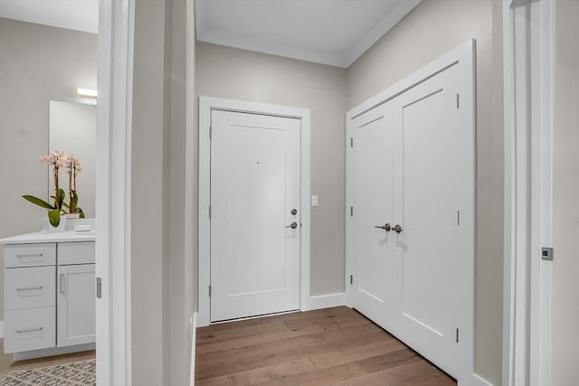 doorway with light wood-type flooring and baseboards