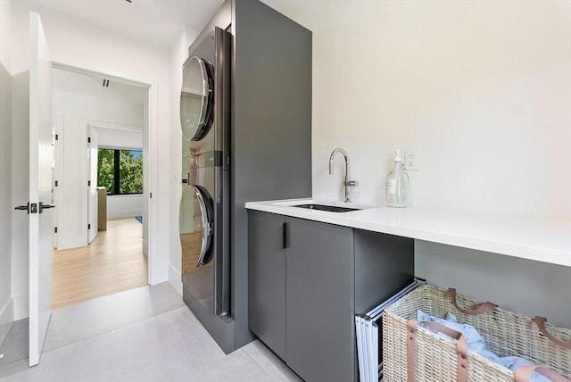 135 Beach St, Cohasset, MA 02025 - washroom featuring stacked washing machine and dryer and cabinet space