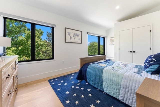 135 Beach St, Cohasset, MA 02025 - bedroom with light wood finished floors, baseboards, and a closet