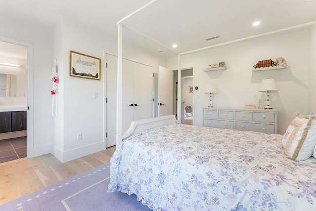 135 Beach St, Cohasset, MA 02025 - bedroom featuring wood finished floors, ensuite bath, baseboards, and recessed lighting