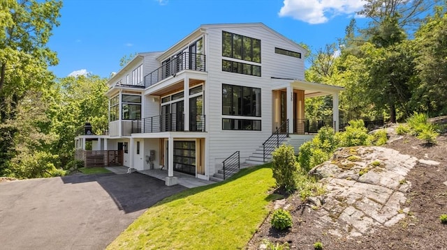 135 Beach St, Cohasset, MA 02025 - back of property featuring a balcony, stairway, a yard, and driveway