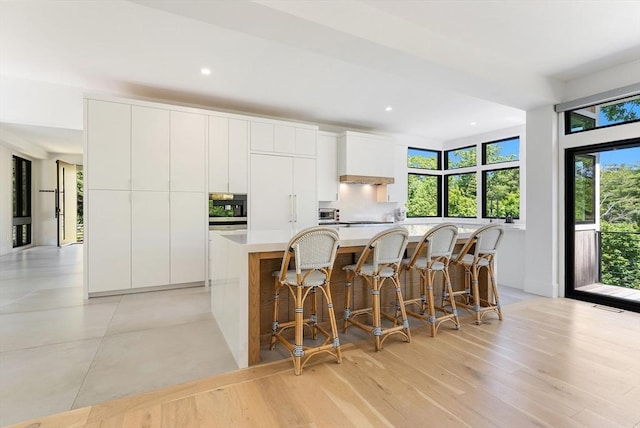 135 Beach St, Cohasset, MA 02025 - kitchen featuring modern cabinets, a large island, white cabinetry, and recessed lighting