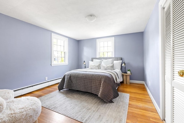 11-13 Turner Ter, Newton, MA 02460 - bedroom with a baseboard radiator, wood finished floors, and a closet