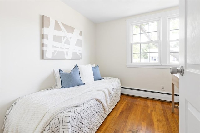 11-13 Turner Ter, Newton, MA 02460 - bedroom featuring a baseboard heating unit and wood finished floors