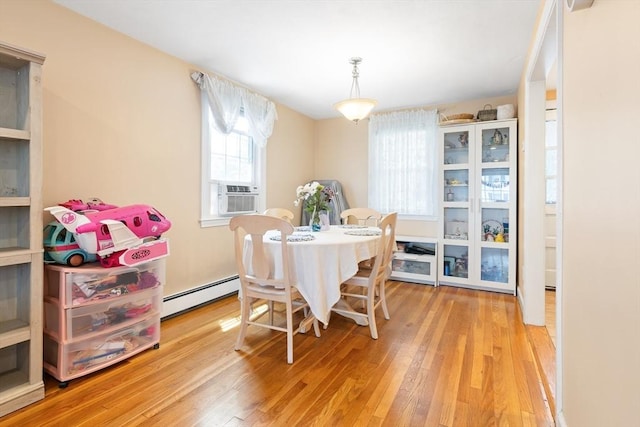 11-13 Turner Ter, Newton, MA 02460 - dining area with a baseboard radiator, wood finished floors, and cooling unit
