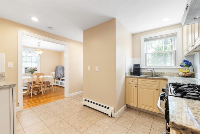 11-13 Turner Ter, Newton, MA 02460 - kitchen with baseboard heating, cream cabinets, light stone counters, light tile patterned floors, and recessed lighting