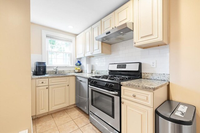 11-13 Turner Ter, Newton, MA 02460 - kitchen with appliances with stainless steel finishes, under cabinet range hood, cream cabinets, backsplash, and light stone countertops