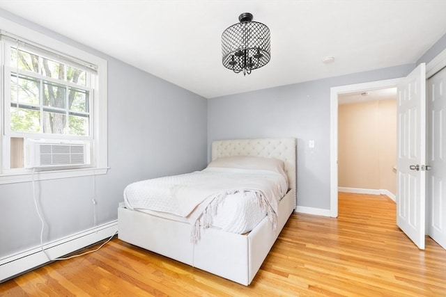 11-13 Turner Ter, Newton, MA 02460 - bedroom with a baseboard heating unit, light wood-style floors, and cooling unit