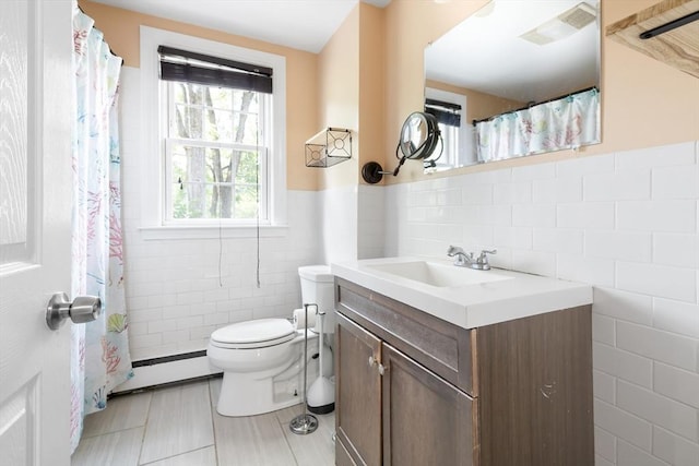 11-13 Turner Ter, Newton, MA 02460 - full bathroom with tile walls, a baseboard radiator, vanity, tile patterned floors, and wainscoting