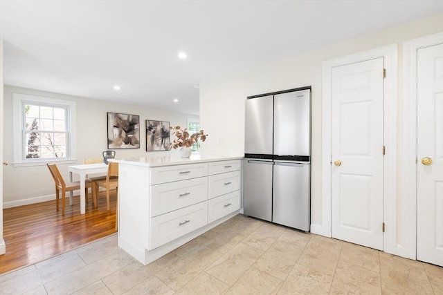 11-13 Turner Ter, Newton, MA 02460 - kitchen featuring freestanding refrigerator, light countertops, a peninsula, white cabinets, and recessed lighting