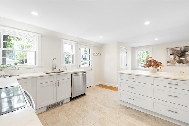 11-13 Turner Ter, Newton, MA 02460 - kitchen with stainless steel dishwasher, recessed lighting, light countertops, white cabinets, and range with electric stovetop