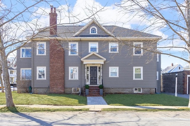 view of front of property featuring a chimney and a front lawn