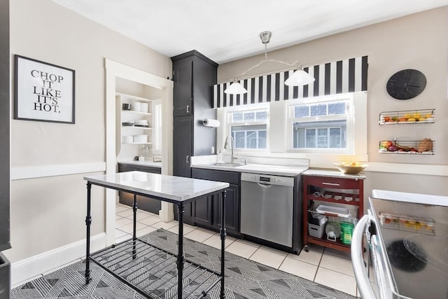 kitchen with light tile patterned floors, dishwasher, light countertops, dark cabinetry, and a sink