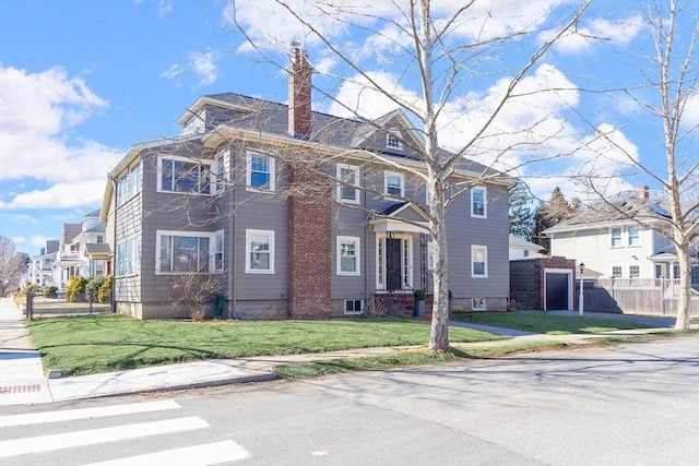 view of front of home featuring a residential view, a chimney, fence, and a front yard