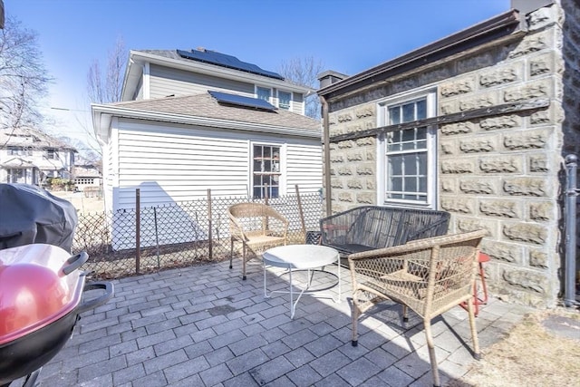 view of patio with a grill and fence