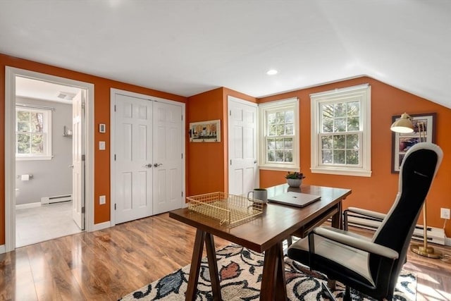 office area with a baseboard heating unit, recessed lighting, light wood-style floors, baseboards, and vaulted ceiling