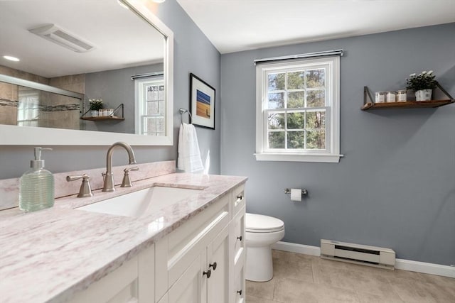 full bath with a wealth of natural light, toilet, baseboards, and baseboard heating