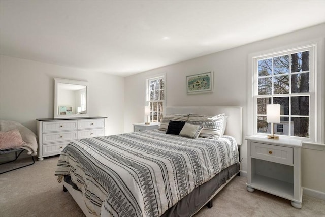 carpeted bedroom featuring baseboards