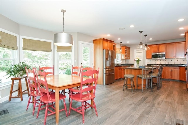 dining area with recessed lighting, light wood finished floors, and visible vents