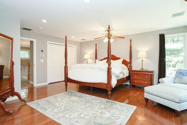 bedroom with multiple windows, light wood-style floors, and visible vents