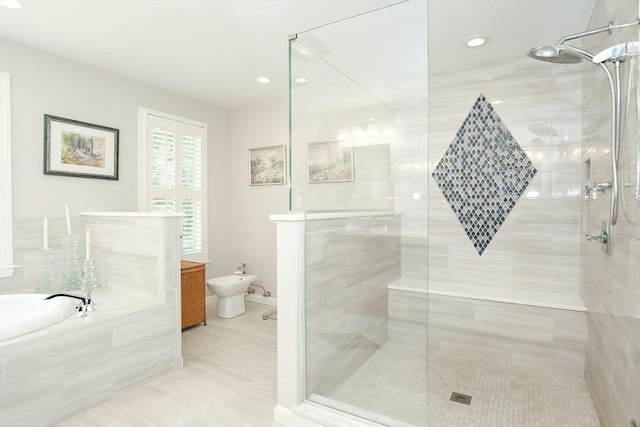 full bath featuring a garden tub, a stall shower, tile patterned flooring, and a bidet